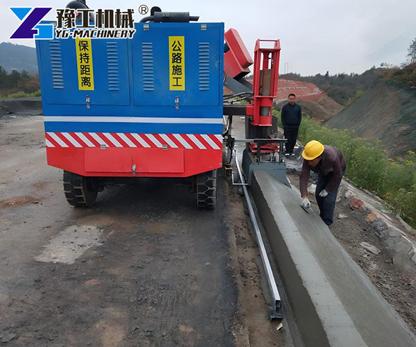 Continuous concrete barrier forming machine