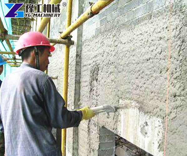 mortar spray machine spraying the wall